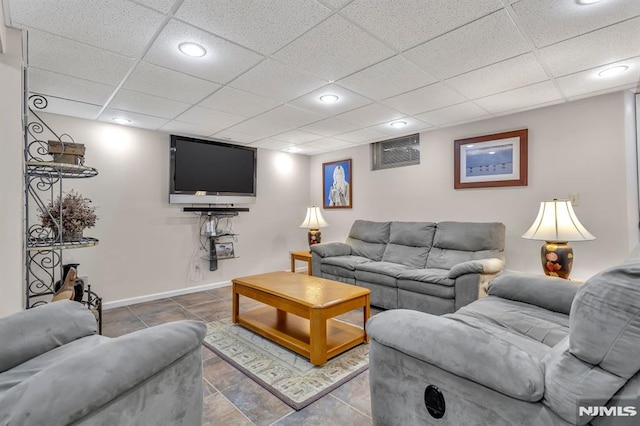 tiled living room with a paneled ceiling