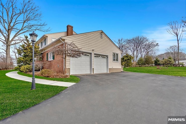 view of side of property with a garage and a yard