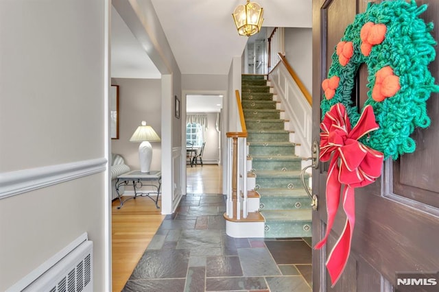 foyer entrance with a chandelier