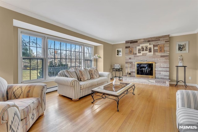 living room with a fireplace, a baseboard radiator, crown molding, and light hardwood / wood-style floors