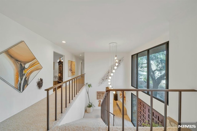 hallway featuring light carpet