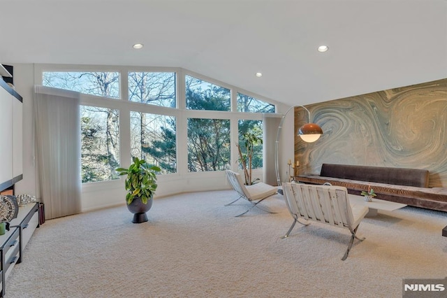 interior space featuring lofted ceiling and light colored carpet