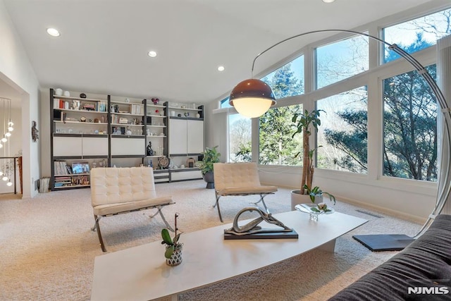 carpeted living room with vaulted ceiling