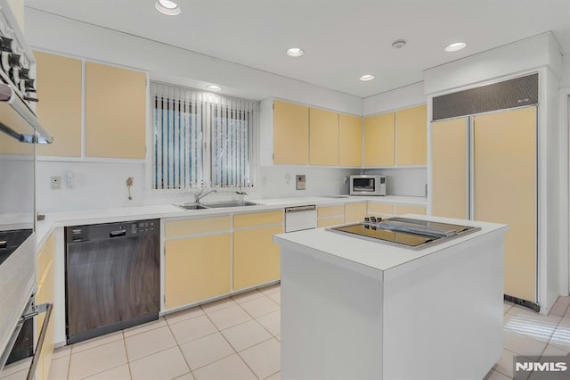 kitchen with sink, light tile patterned flooring, a center island, and black appliances