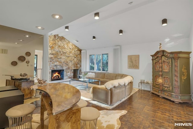 living room featuring a fireplace and vaulted ceiling