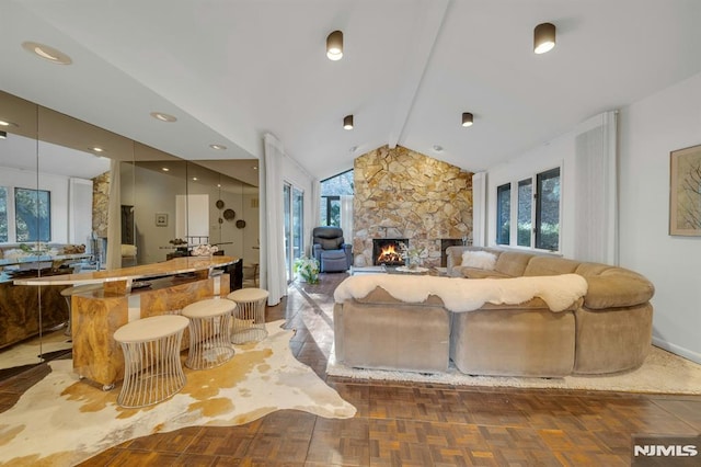 living room with parquet flooring, vaulted ceiling with beams, and a stone fireplace