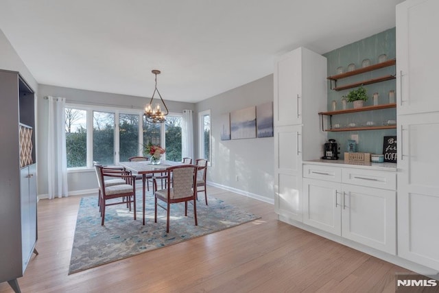 dining room featuring light hardwood / wood-style floors and a notable chandelier