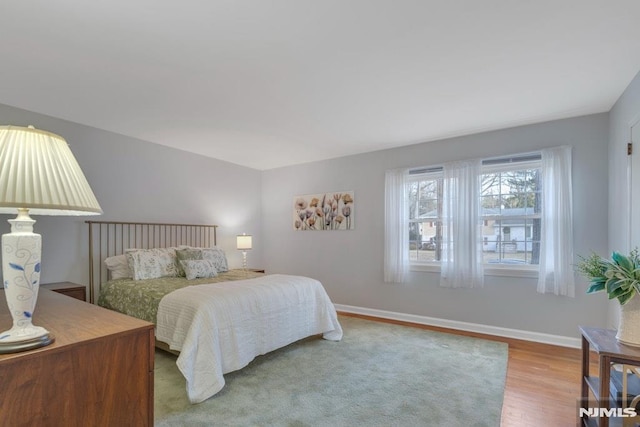 bedroom with hardwood / wood-style flooring