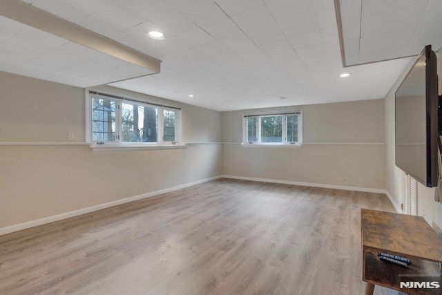 basement with light hardwood / wood-style floors and plenty of natural light