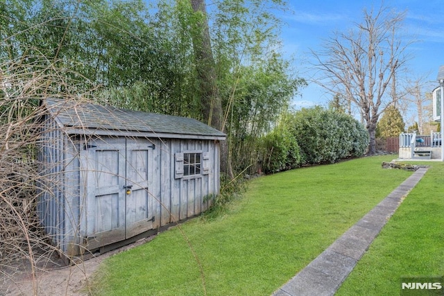 view of outdoor structure with a lawn