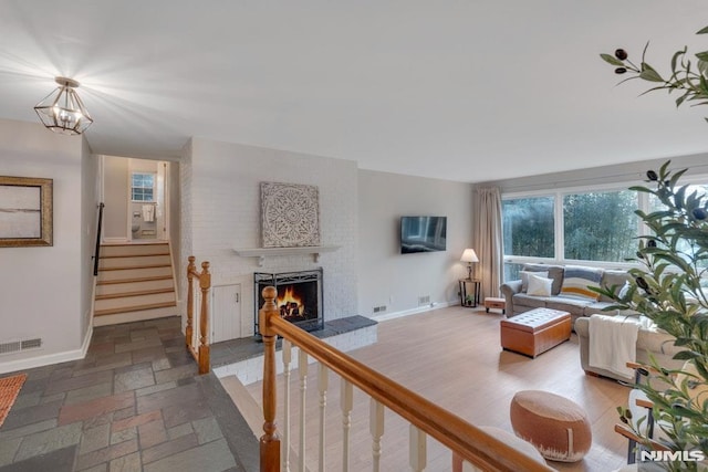 living room with a brick fireplace