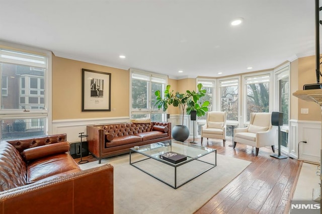 living room featuring light wood-type flooring and ornamental molding