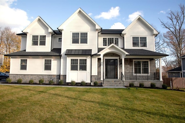 view of front of home featuring covered porch and a front yard