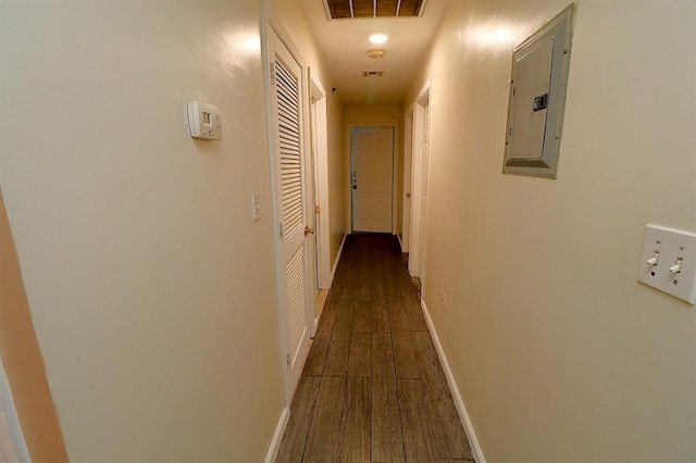 hall with electric panel and dark wood-type flooring