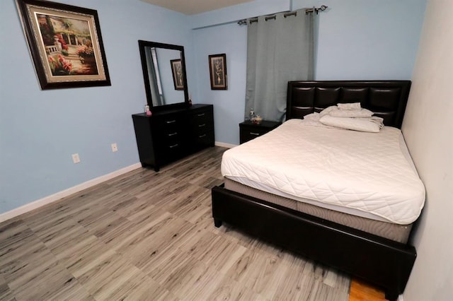 bedroom with hardwood / wood-style flooring