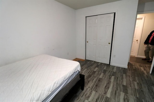 bedroom featuring a closet and dark hardwood / wood-style flooring