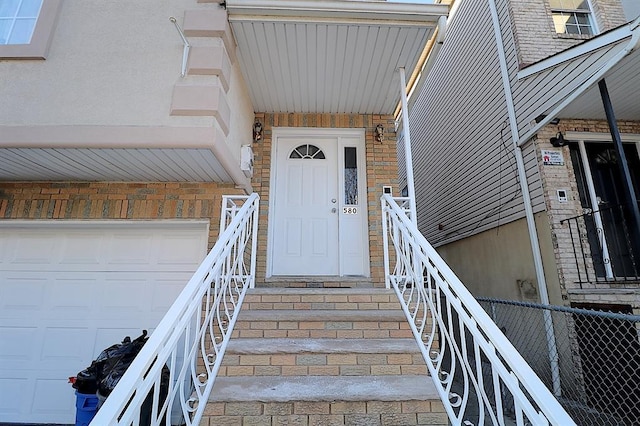 doorway to property with a garage