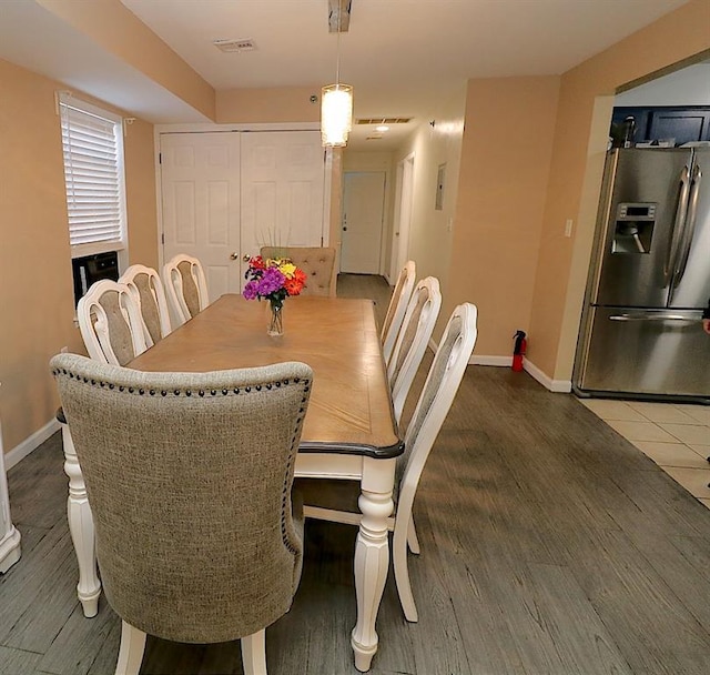 dining space with dark hardwood / wood-style flooring