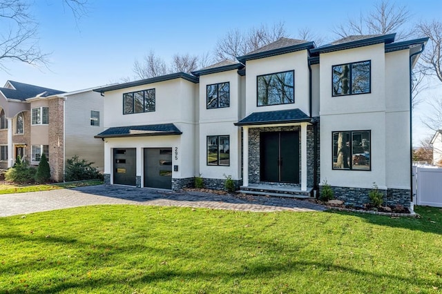 view of front of house with a garage and a front lawn