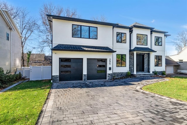 view of front of property featuring a garage and a front yard