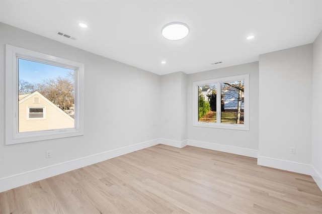 empty room with light hardwood / wood-style flooring