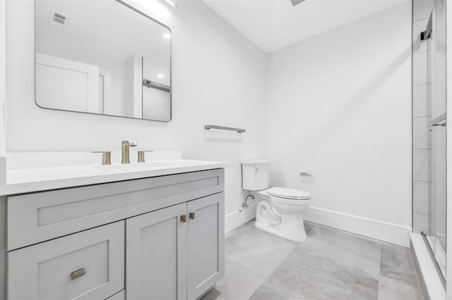 bathroom with vanity, toilet, and a shower with shower door