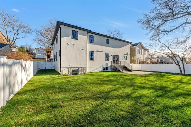 rear view of property with a lawn