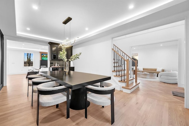 dining space featuring a raised ceiling