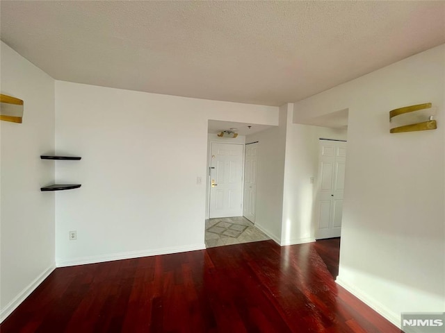 spare room featuring wood-type flooring