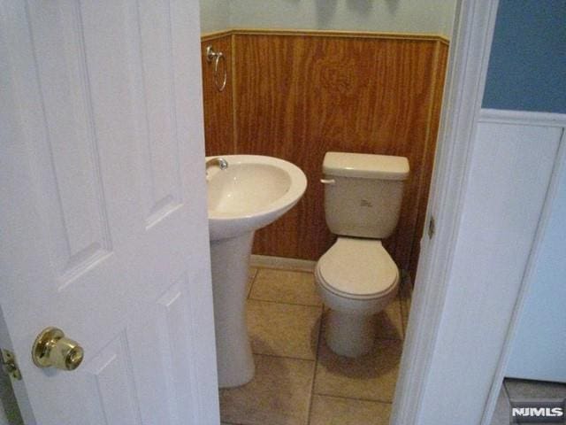 bathroom with tile patterned floors and toilet