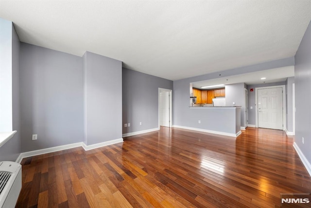 unfurnished living room with hardwood / wood-style floors