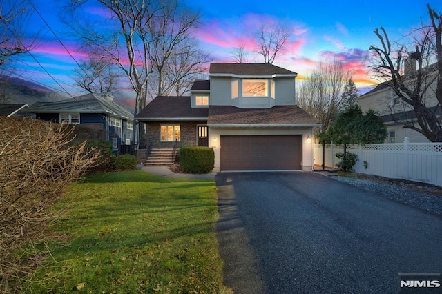 view of front of home with a lawn and a garage