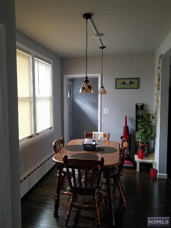 dining room with dark hardwood / wood-style floors and baseboard heating