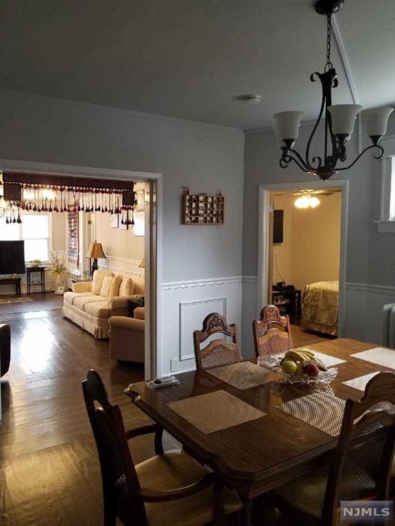 dining area with an inviting chandelier and radiator