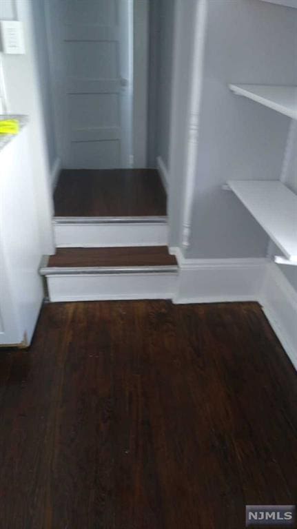 stairway featuring hardwood / wood-style flooring