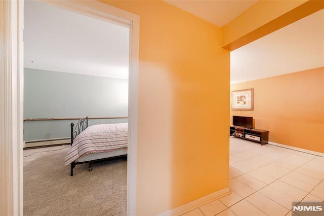 hallway with light tile patterned floors and a baseboard radiator