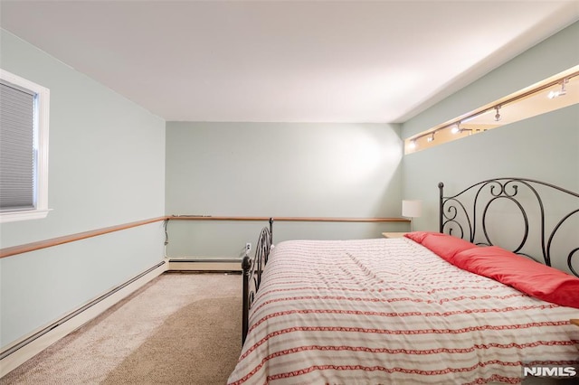 bedroom featuring light colored carpet and baseboard heating