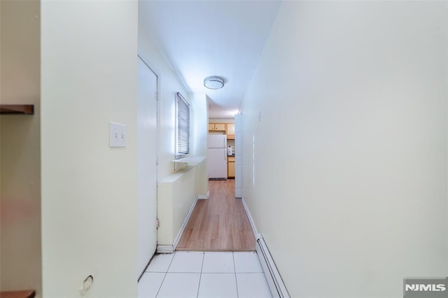 hall featuring light tile patterned floors