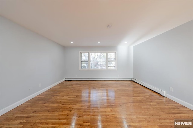 spare room with light hardwood / wood-style floors and baseboard heating