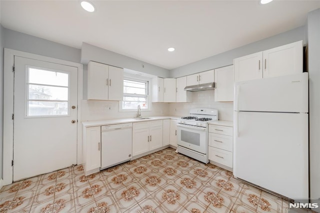 kitchen with white cabinetry, sink, white appliances, and backsplash