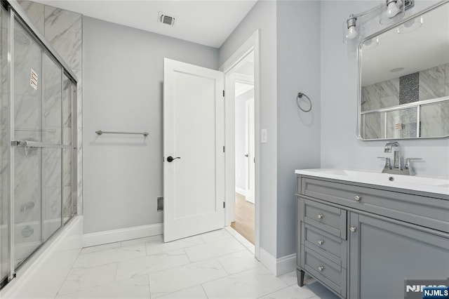 bathroom with vanity and shower / bath combination with glass door