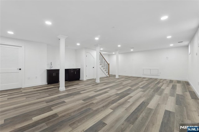 basement with hardwood / wood-style floors