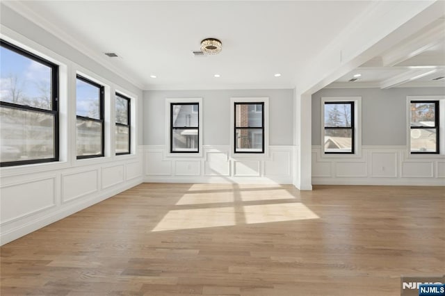 spare room with crown molding and light hardwood / wood-style floors