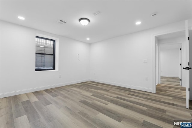 unfurnished room with hardwood / wood-style flooring