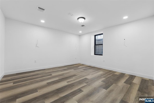 empty room with hardwood / wood-style floors