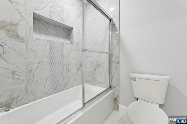 bathroom with shower / bath combination with glass door and toilet