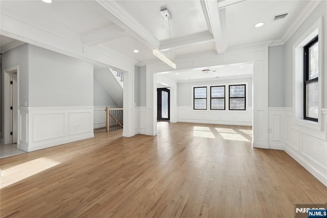 unfurnished living room with coffered ceiling, beam ceiling, and light wood-type flooring