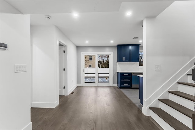 corridor with baseboards, stairway, dark wood finished floors, and recessed lighting