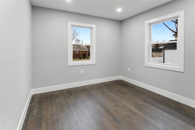 unfurnished room with plenty of natural light and baseboards