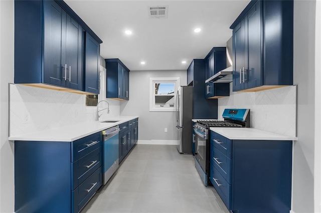 kitchen featuring blue cabinetry, appliances with stainless steel finishes, a sink, and visible vents